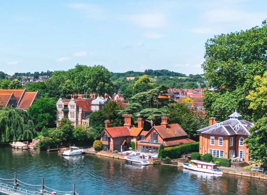 Marlow Riverside, Thames Valley Riverside view of Marlow on the River Thames with traditional red-tiled houses and moored boats