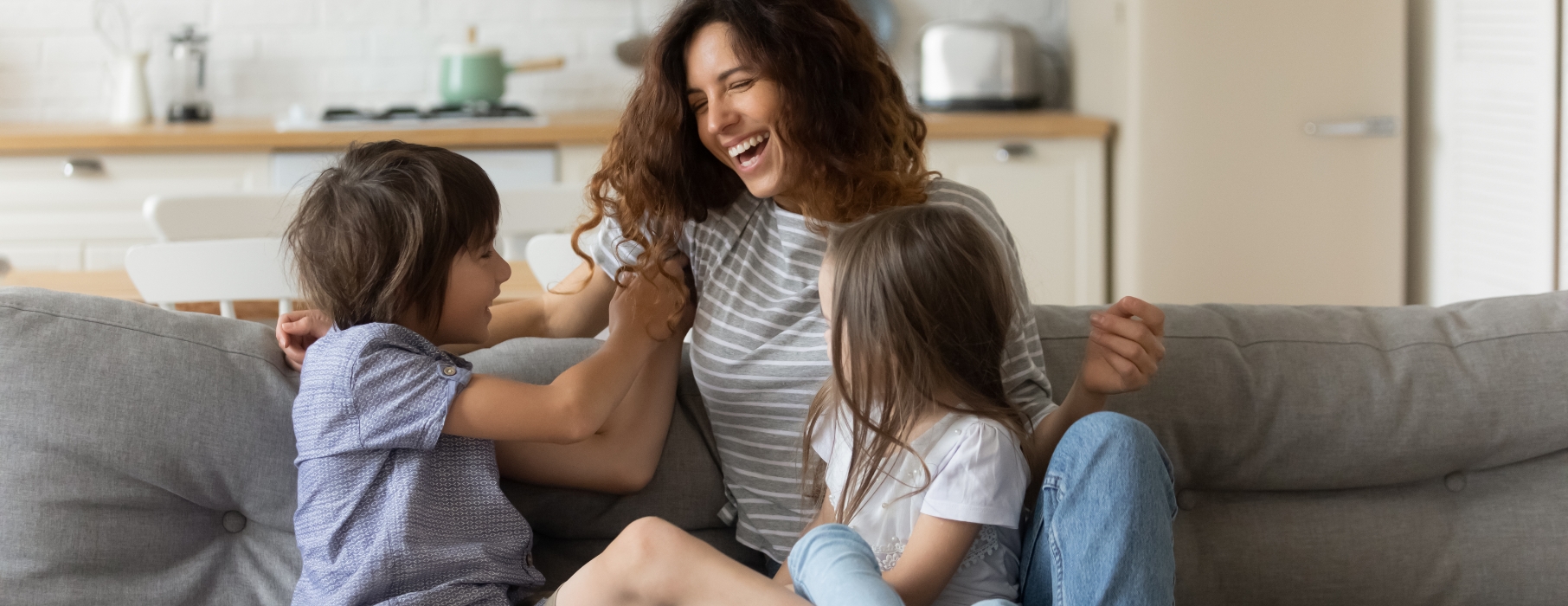 A lady laughing with her children