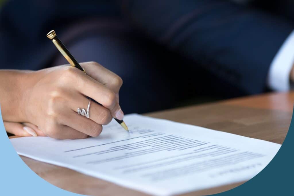A lady signing a financial settlement document