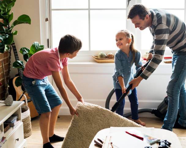 Two children helping out with chores in the house